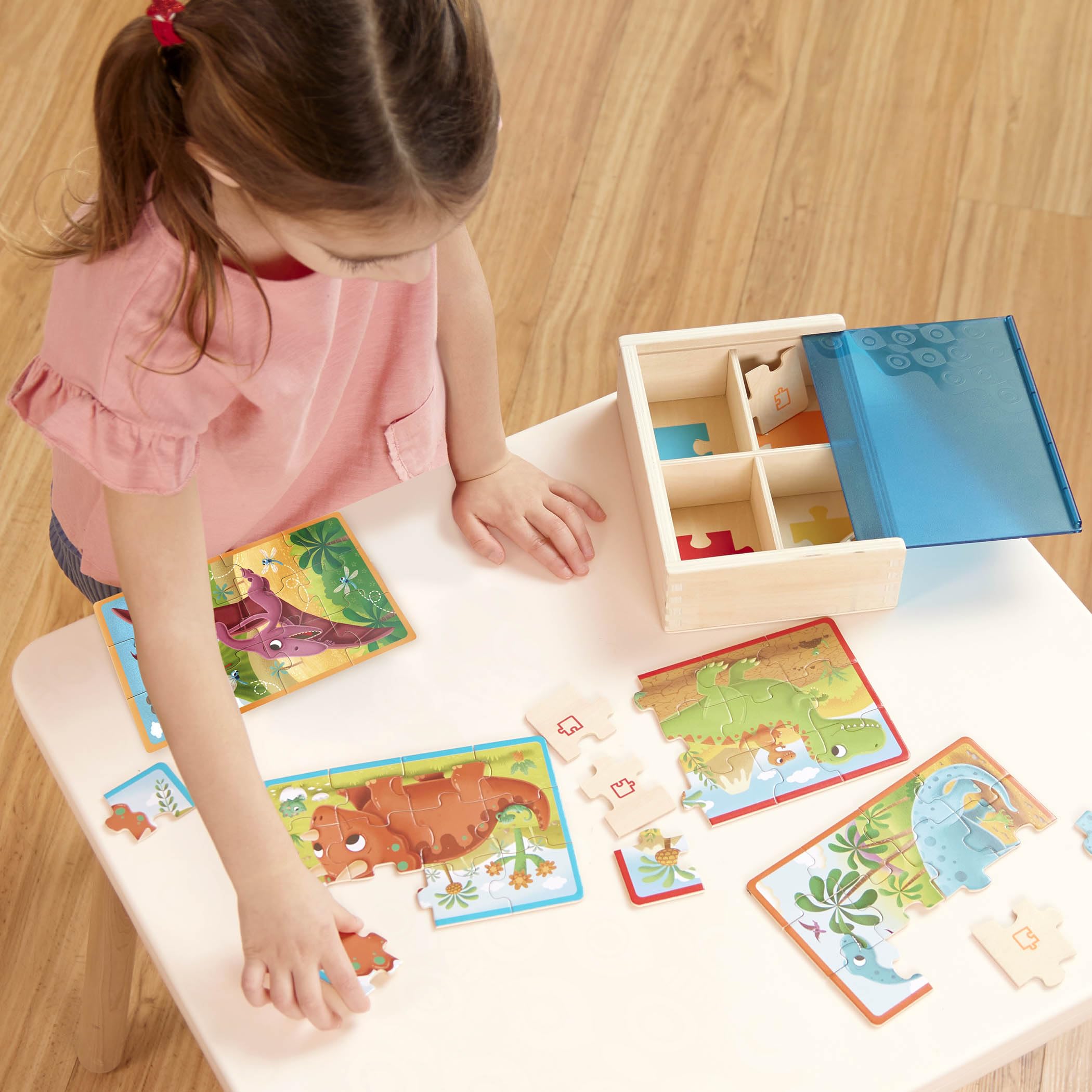 B. toys Pack o' Puzzles: 4 Wooden Dinosaur Jigsaw Puzzles for Kids Ages 3+